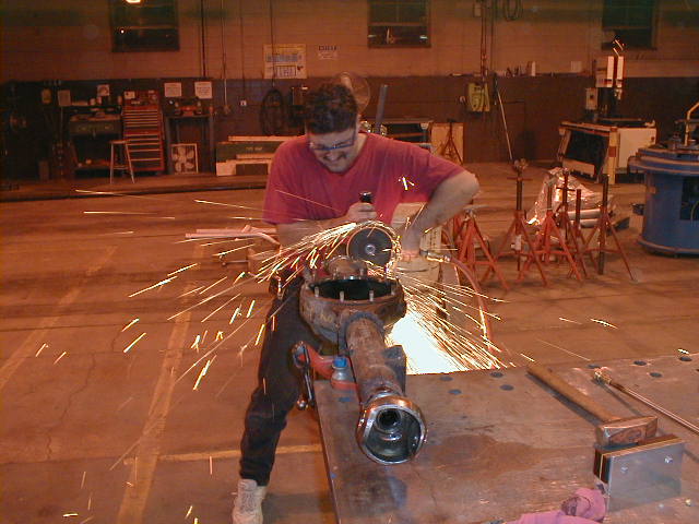 Jim with a 7 inch grinder, cutting thru the weld where the kunckle sleeves into the main housing.